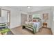 Bright bedroom with a queen bed, bench, and neutral colors at 1920 Kimball S Ct, Lakeland, FL 33813