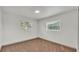 Empty bedroom features neutral carpet and two bright windows at 1920 Kimball S Ct, Lakeland, FL 33813