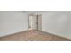 Empty bedroom features neutral carpet and open door at 1920 Kimball S Ct, Lakeland, FL 33813