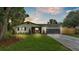 Charming single-story home featuring a well-manicured lawn, two-car garage, and stylish architectural details at 1920 Kimball S Ct, Lakeland, FL 33813