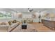 Bright living room with light hardwood floors, neutral paint, and modern furnishings at 1920 Kimball S Ct, Lakeland, FL 33813