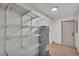 Spacious storage room with shelving, a water heater, and a door to access other rooms at 1920 Kimball S Ct, Lakeland, FL 33813