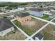 Aerial view of a spacious backyard enclosed by a white fence, set in a peaceful residential neighborhood at 2170 Forest Lake Ave, Dundee, FL 33838