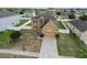 Aerial view of tan two-story home in a residential neighborhood with fenced yards at 2170 Forest Lake Ave, Dundee, FL 33838