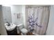 Bathroom with a vanity sink, toilet, and a bathtub with a shower curtain at 2170 Forest Lake Ave, Dundee, FL 33838