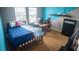 Bedroom featuring blue accent walls, modern furniture, with a dedicated desk area, perfect for work or study at 2170 Forest Lake Ave, Dundee, FL 33838