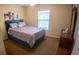 Bedroom featuring a queen-sized bed, window with blinds, and a dresser at 2170 Forest Lake Ave, Dundee, FL 33838