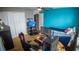 Well-lit bedroom, complete with a workspace featuring dual monitors, alongside a cozy bed for relaxation at 2170 Forest Lake Ave, Dundee, FL 33838