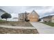 Two-story home with tan exterior, attached garage, and simple landscaping on an overcast day at 2170 Forest Lake Ave, Dundee, FL 33838