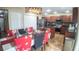Eat-in kitchen features stainless steel appliances, wood cabinets, island with chairs and modern lighting at 2170 Forest Lake Ave, Dundee, FL 33838