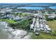 Stunning aerial view of lakeside townhomes with a community pool and boat dock, surrounded by lush landscaping at 2203 Starboard, Winter Haven, FL 33881
