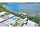 Aerial shot of waterfront townhomes with a community pool and dock overlooking the beautiful lake waters at 2203 Starboard, Winter Haven, FL 33881