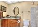 Bathroom features a granite countertop, wood cabinet, and tiled shower at 2203 Starboard, Winter Haven, FL 33881