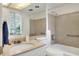 Bright bathroom with a marble countertop and a bathtub with a shower at 2203 Starboard, Winter Haven, FL 33881