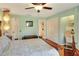 A bright bedroom features a large bed and a view into an adjacent bathroom at 2203 Starboard, Winter Haven, FL 33881