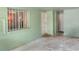 Mint colored breezeway of property featuring multiple entry doors and a window with security bars at 2203 Starboard, Winter Haven, FL 33881