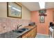 Kitchen with tile backsplash, granite counters, and light wood cabinets, with an 