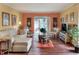 Cozy living room featuring hardwood floors, comfortable seating, and a sliding door with access to the outdoors at 2203 Starboard, Winter Haven, FL 33881
