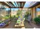 Patio with lush greenery and covered pergola with translucent roof panels at 2203 Starboard, Winter Haven, FL 33881