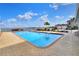 Relaxing pool view featuring clear water, brick-paved patio, and comfortable lounge chairs under a sunny sky at 2203 Starboard, Winter Haven, FL 33881