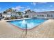 View of community pool with lounge chairs and a covered lounge area at 2203 Starboard, Winter Haven, FL 33881