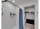 Bathroom with white tile shower and blue shower curtain at 2244 Teneroc Trl, Lakeland, FL 33801