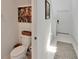 View of a toilet and wall decor in the bathroom at 2244 Teneroc Trl, Lakeland, FL 33801