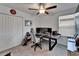 Bedroom with carpeted floors, a ceiling fan, and a spacious workspace with a large desk and multiple monitors at 2244 Teneroc Trl, Lakeland, FL 33801