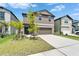 View of a two-story home with a well-maintained lawn and landscaping at 2244 Teneroc Trl, Lakeland, FL 33801