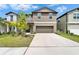 Two-story home with neutral siding, a two-car garage, and landscaping at 2244 Teneroc Trl, Lakeland, FL 33801