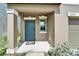 A close-up of the front door featuring a blue door and a window at 2244 Teneroc Trl, Lakeland, FL 33801
