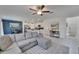 Open-concept living room featuring a large sectional sofa, modern ceiling fan, and view into the kitchen at 2244 Teneroc Trl, Lakeland, FL 33801