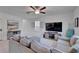 Open-concept living room featuring a large sofa, TV, and neutral decor at 2244 Teneroc Trl, Lakeland, FL 33801
