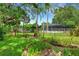 Picturesque backyard featuring lush landscaping and an in ground pool with a screen enclosure at 2632 Handley Blvd, Lakeland, FL 33803