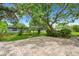 Paver patio beneath mature trees in a large backyard setting with green grass at 2632 Handley Blvd, Lakeland, FL 33803