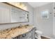 Bright bathroom featuring granite countertops, a large mirror, and a shower-tub combination at 2632 Handley Blvd, Lakeland, FL 33803