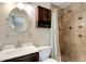 Cozy bathroom featuring a shower with decorative tile and a dark wood vanity cabinet at 2632 Handley Blvd, Lakeland, FL 33803