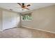 Bedroom featuring tile flooring, a ceiling fan, a closet with white bi-fold doors, and a window at 2632 Handley Blvd, Lakeland, FL 33803