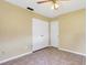 Bedroom featuring tile flooring, a ceiling fan, and a closet with white bi-fold doors at 2632 Handley Blvd, Lakeland, FL 33803