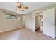 Spacious bedroom featuring tile flooring, a ceiling fan, and multiple windows for natural light at 2632 Handley Blvd, Lakeland, FL 33803