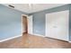 Blue bedroom with tile flooring, double closet, and attached bathroom at 2632 Handley Blvd, Lakeland, FL 33803