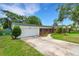 Traditional home with attached garage, beautiful landscaping, and mature trees at 2632 Handley Blvd, Lakeland, FL 33803