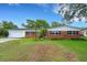 Traditional brick home with lush green lawn and mature trees, offering a comfortable and inviting curb appeal at 2632 Handley Blvd, Lakeland, FL 33803