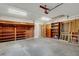 Garage featuring a brick wall with wooden shelves, offering ample storage space at 2632 Handley Blvd, Lakeland, FL 33803