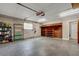 Spacious garage interior with storage shelving, brick accent wall, and concrete flooring at 2632 Handley Blvd, Lakeland, FL 33803