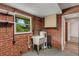 Laundry room featuring brick walls, utility sink, and cabinet storage at 2632 Handley Blvd, Lakeland, FL 33803