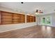 Versatile living space with hardwood floors, built-in shelving, and French doors to the backyard, perfect for entertaining at 2632 Handley Blvd, Lakeland, FL 33803