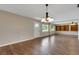 Open living room with hardwood floors, a pendant light fixture, and natural light, offering a versatile living space at 2632 Handley Blvd, Lakeland, FL 33803
