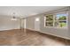 Bright, spacious living room with hardwood floors, showcasing an open layout and natural light from a large window at 2632 Handley Blvd, Lakeland, FL 33803