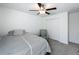 Neutral bedroom with ceiling fan, gray carpet, and a cozy chair at 2929 Flying Blackbird Rd, Bartow, FL 33830